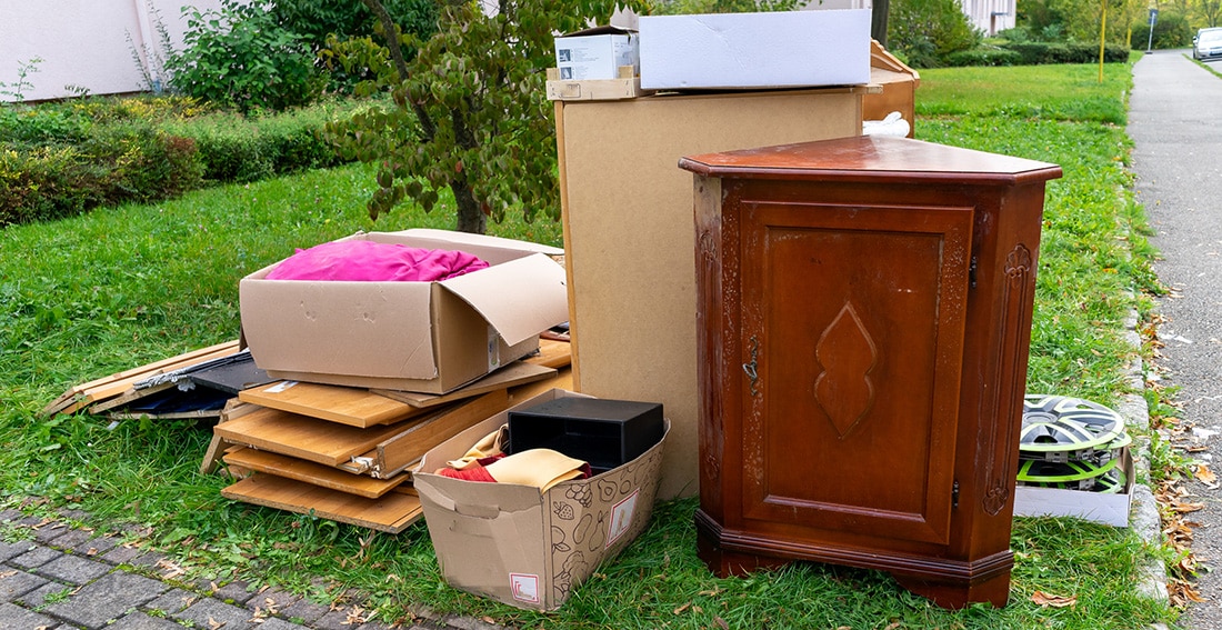 Old furniture and junk in a yard ready for removal